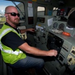 An engineer sits in a locomotive preparing for a trip