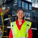 A conductor and engineer pose of a photo