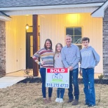 Dustin Collie and his family celebrate buying their first home.