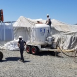 Filling up the pod with sand for the sand blasting