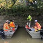 WEST Engineers and Scientists take a break on the river bank during a field site visit.