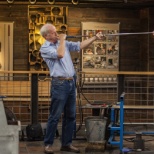 Simon Pearce blows glass at The Mill in Quechee, Vermont.