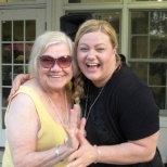 Atria Willistown resident and staff share a laugh on the terrace.