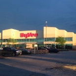 The sun peeks through the clouds to highlight the 90th and West Center Road HyVee in Omaha, Nebraska