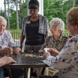 Summer Village residents building connections and playing cards.