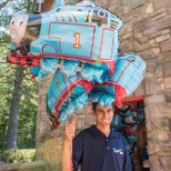 Here is an employee selling balloons on a summer day