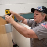 A plant manager works to fix a door at Cimarron Springs Middle School.