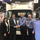 Shaun Skinner, President of Isuzu Commercial Trucks of America, presents an award to Norb Markert