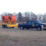 Truck pulling a reel of innerduct.