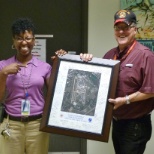 My boss on the left is presenting me with a beautiful retirement plaque on my last day.