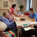 The wonderful activities team play bingo with the lovely residents at Chestnut Manor Care Home.