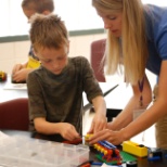 YEL Teacher making a young STEM student's day a bit brighter.