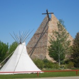 Tipi in foreground and church in background