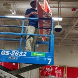 Using a scissor lift to hang banners!