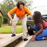 Pop-A-Lock Roadside Technician helping a customer who is locked out of their vehicle