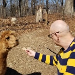 Albert enjoying feeding the animals