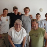 students helping a lady clean up her garage.