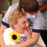 Resident with a staff member at a home event.