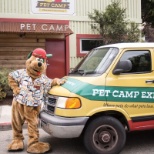 Out front of the main campus with a doggie transport van and the mascot Campy!