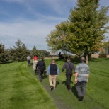 Employees walking on the path surrounding Anderson Trucking Service (ATS) headquarters