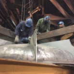 Putting cap on a 50 ton holding furnace after a re-line.