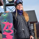 Young snowboarder poses for a a portrait in front of the iconic Hidden Valley Clock Tower