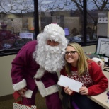 Santa (aka ExactCare President & CEO) dons a purple suit to hand out holiday bonuses every year