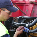 Driver checking oil during pretrip