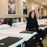 District Sales Manager Joni models a luxurious Tempur-Pedic mattress.