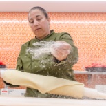 A Bon Appétit chef tosses pizza dough at an on-site learning kitchen