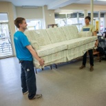 Moving donated furniture in an MCC Thrift Shop in Saskatchewan, Canada