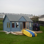 Our surf shack where our team can borrow wetsuits and surfboards from.