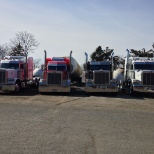 A couple trucks in the yard.