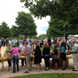 Team members get produce from a local vendor at a Farmer's Market sponsored by one of our suppliers