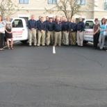 Office staff and technicians gather after meeting for a group photo in Philadelphia.