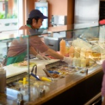 Associate serving a customer at Bay Market.