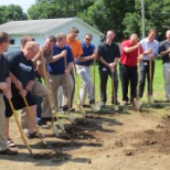 Management team attending the ground-breaking for their 4th Habitat for Humanity house in 3 years.