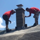 Two crew members rebuilding a block chimney for Habitat For Humanity July 2016