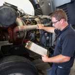 Technician diagnosing a truck in our service shop.