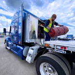 One of our flatbed drivers get ready to tarp a load. Tarp Pay is in addition to driver salary.