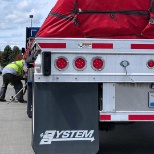 One of our hard-working flatbedders doing a safety check before his route.