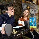 Teresa is supported by her Job Coach as she reads stories at Madison's Children's Museum.