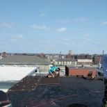 Putting down a flat rubber roof on 3 story tenant.