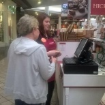 Hickory Farms Kiosk, associate assisting a customer