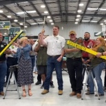 Store Manager, Drew Van Winkle, opens our newest store with a McCoy's traditional Board Cutting