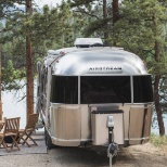 An Airstream in the woods.