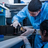 Scientists in the AeroCube lab assembling a small satellite.