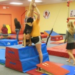 During class. Grade school, Students are showing off their Front Handspring Skills.