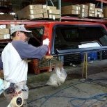 Paint repair team members check the final painted product to ensure there are no defects