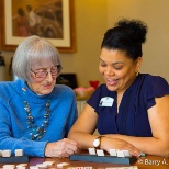 A resident and an associate playing dominoes